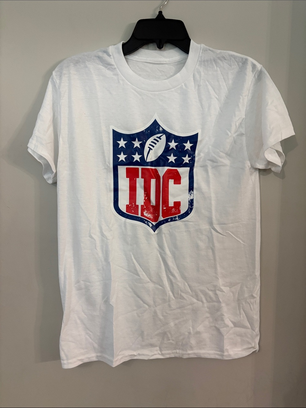 White Graphic Tee with Red & Blue Shield Logo